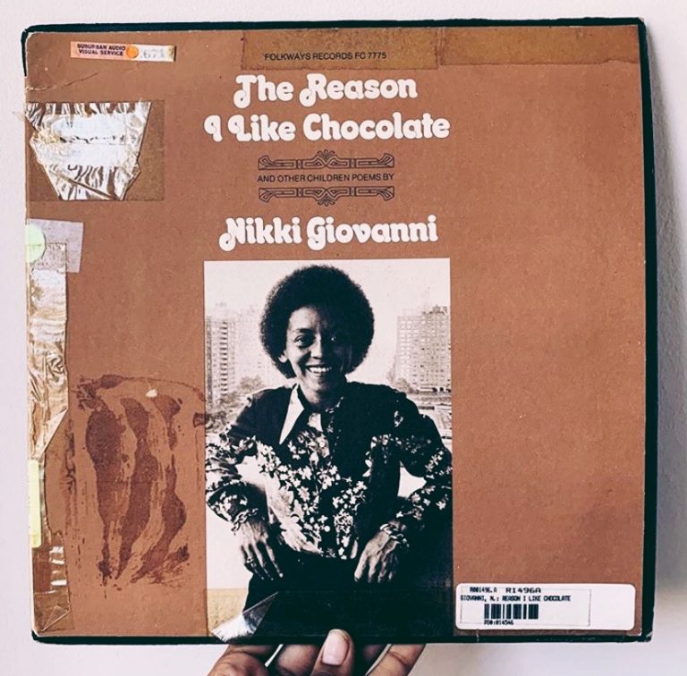 A hand holds a vintage Folkways record with a photo of Nikki Giovanni and text that reads "The Reason I Like Chocolate and Other Children Poems by Nikki Giovanni"