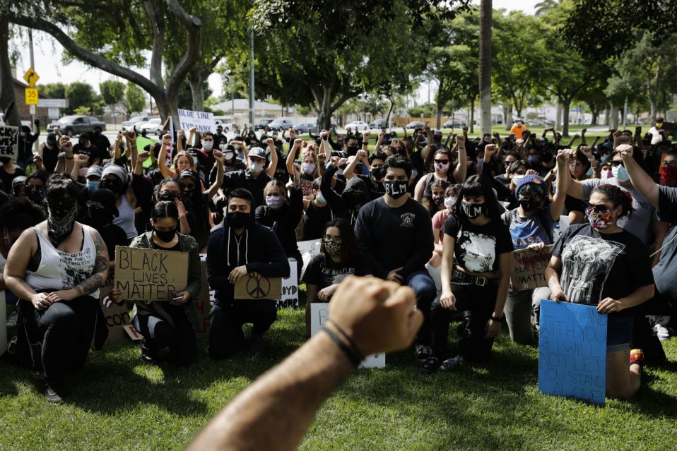 In this June 1, 2021 photo, demonstrators raise their fists during a protest over the death of George Floyd in Anaheim, California.