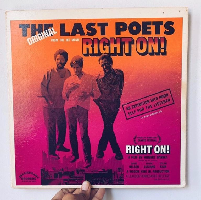 A hand holds a vintage record with a picture of three smiling men posing and text that reads "The original last poets from the hit movie RIGHT ON! An expedition into inner self for the listener" and information about the film RIGHT ON!, a film by Herbert Danska, and a laurel from Cannes Film Festival.