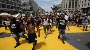In this June 6, 2021 photo, demonstrators protest near the White House in Washington over the death of George Floyd, a black man who was in police custody in Minneapolis.